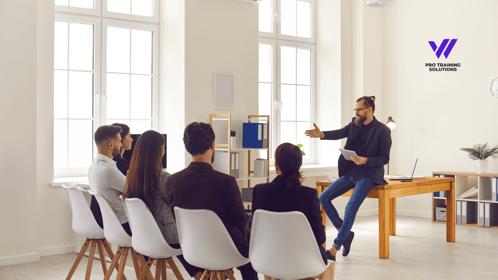 Team using a digital custom training manual during employee onboarding session